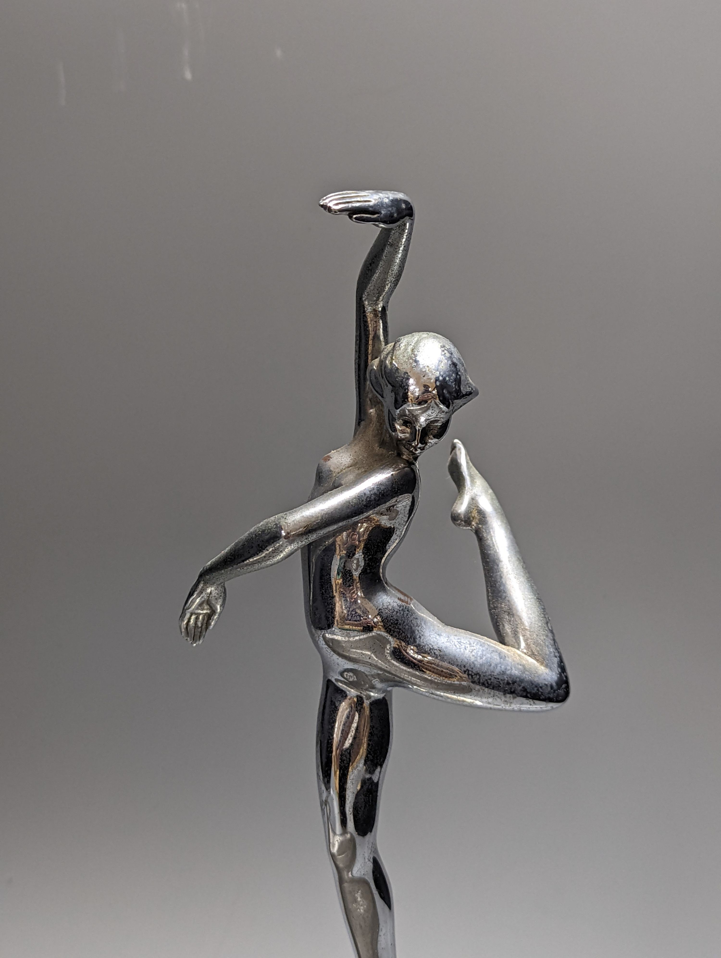 A Kayserzinn oval salmon dish and an Art Deco chromium female statuette 62cm
